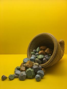 Still Life with Beveled Stones in a Cone on Yellow Background