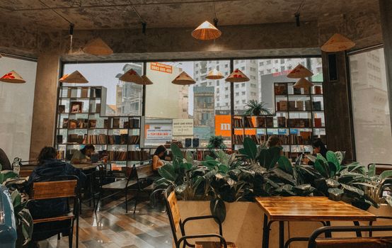 A warm and inviting cafe interior featuring modern design, natural lighting, and a relaxing atmosphere.