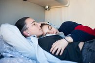 Woman in Black Sweater Lying on Bed