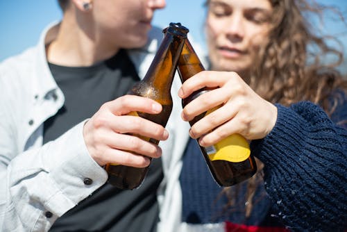 A Couple Doing a Toast with Beer Bottles