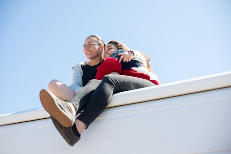 Happy Couple Hugging Each Other While Sitting Together