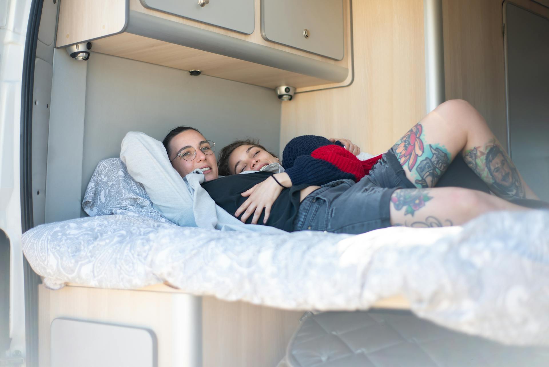 A Couple Lying Together in a Bed Inside a Motorhome