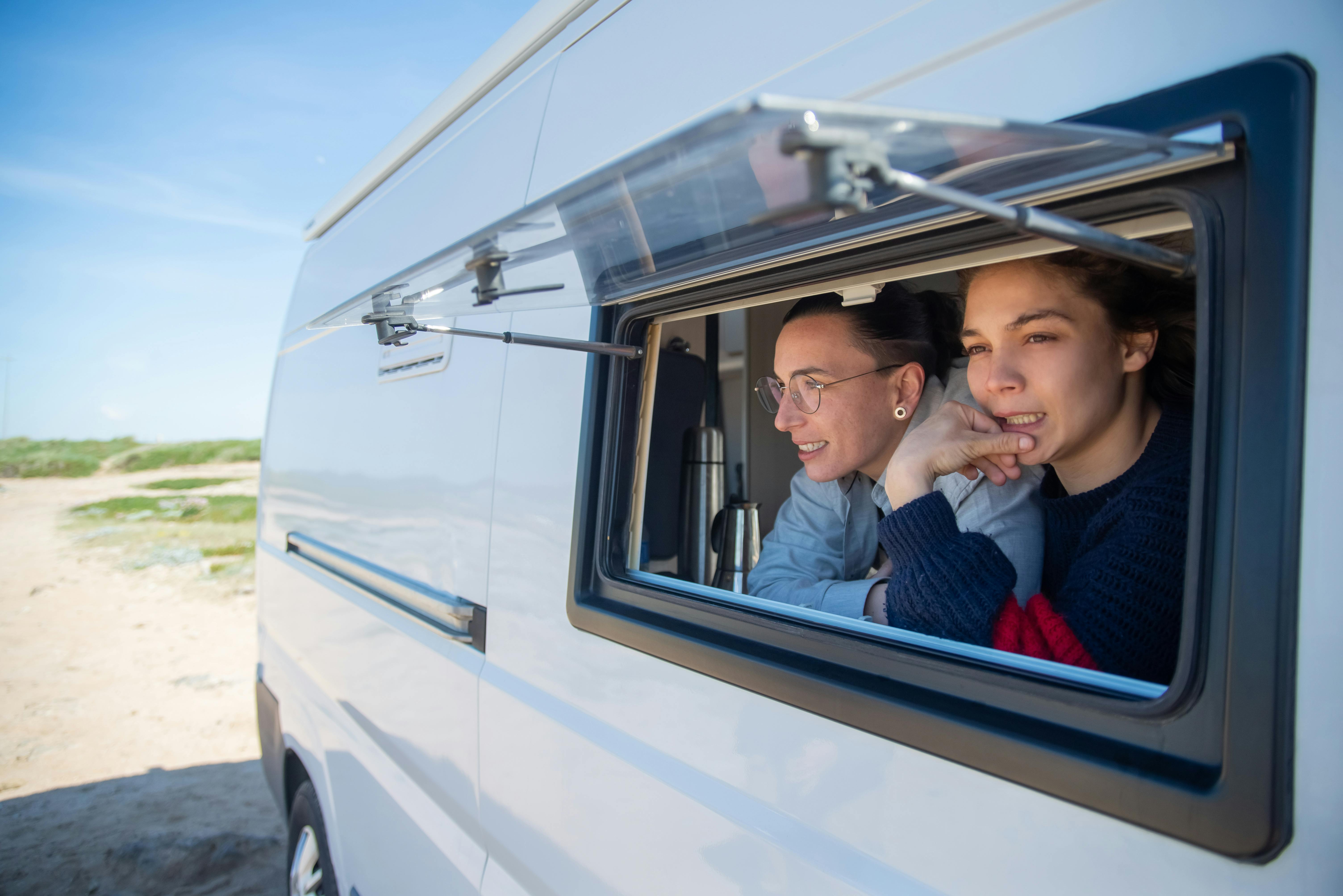 women looking out of a window of an rv