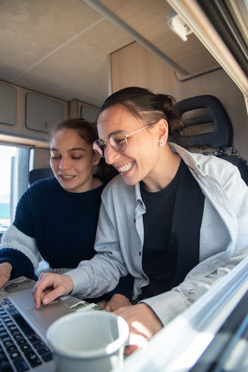 A Couple Using a Laptop Together in an RV