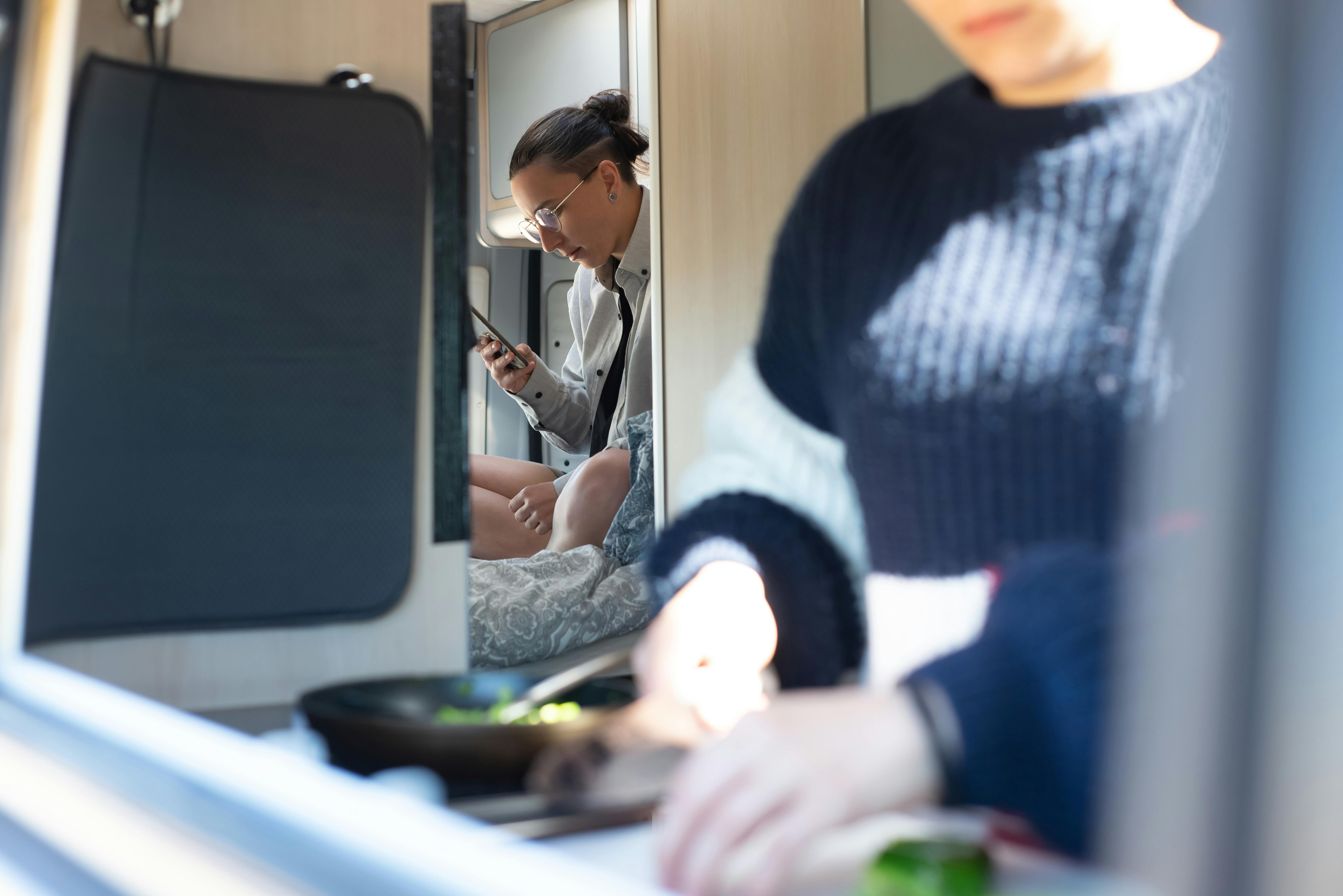 a woman using a cellphone inside an rv