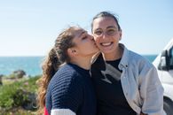 Woman in a Sweater Kissing a Woman with Eyeglasses