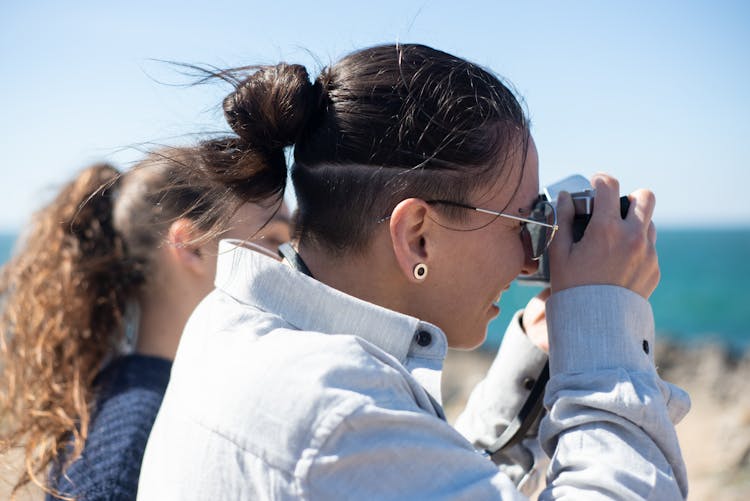 Close-up Side View Of Man Taking A Picture With A Camera 