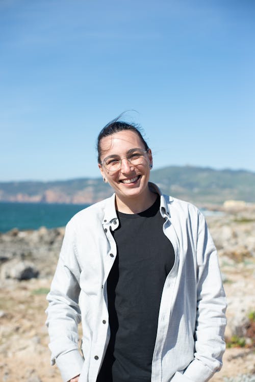 Woman in White Long Sleeves Smiling in Blurred Background 