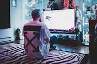 Unrecognizable man playing videogame at home