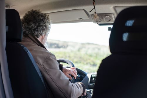 Free A senior man drives a motorhome through picturesque Portuguese countryside, highlighting travel and adventure. Stock Photo