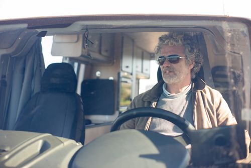 Free Senior man at the wheel of a motorhome enjoying a road trip in Portugal. Stock Photo
