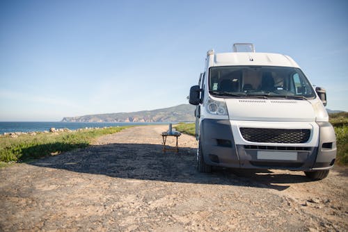 Free White and Black Van on Brown Dirt Road Stock Photo
