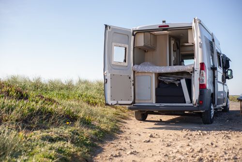 Free Open camper van on a sunny day, perfect for a rural getaway in nature. Stock Photo