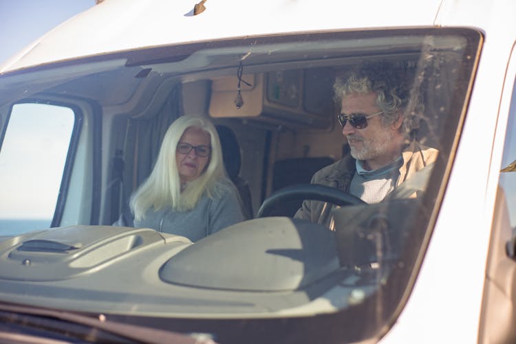 A Couple Travelling In An Recreational Vehicle