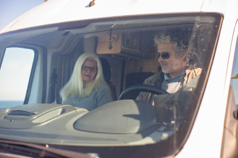 Happy renters behind the wheel of their motorhome