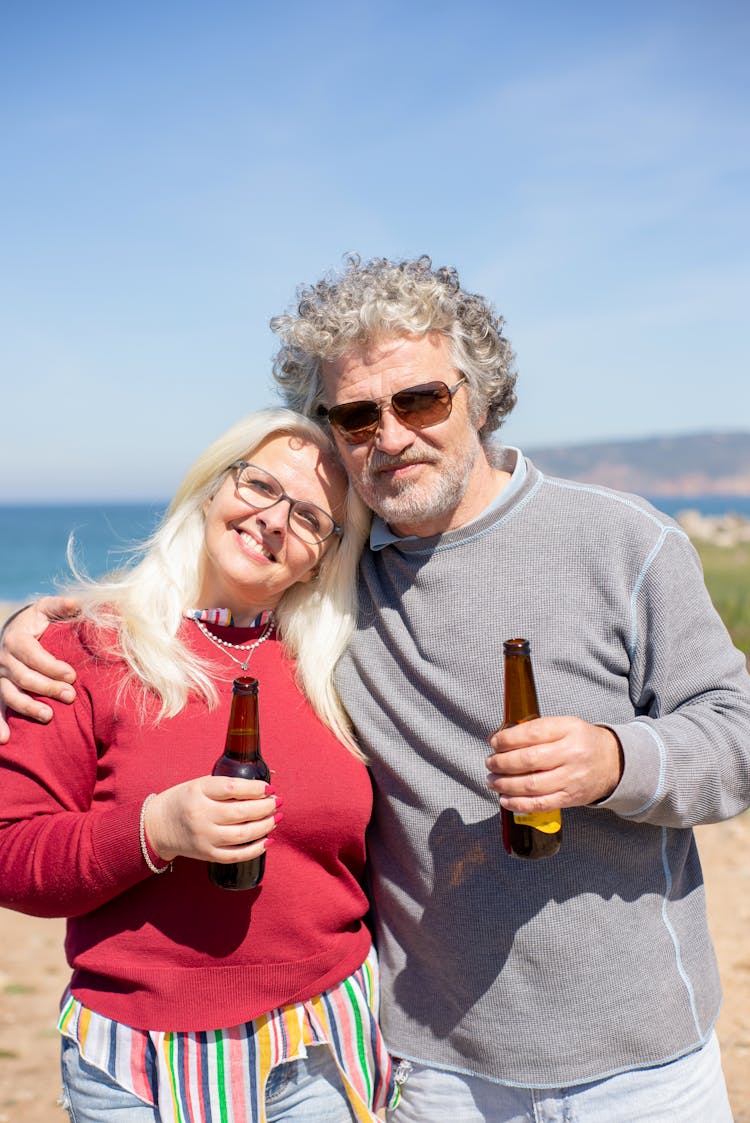 Photo Of A Romantic Elderly Couple Holding Beers 