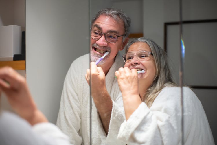 Elderly Couple Brushing Their Teeth