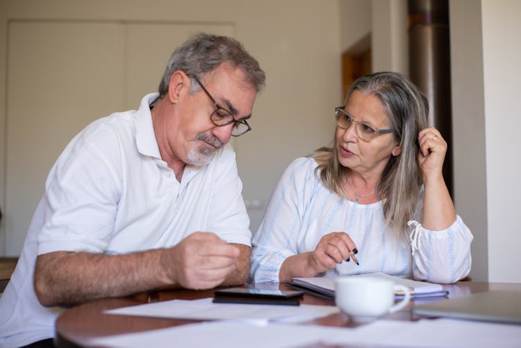 Elderly Couple Completing Documents 