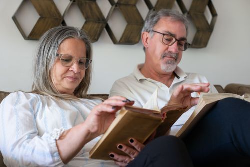 Free Elderly couple enjoying books together in a cozy living room setting. Stock Photo