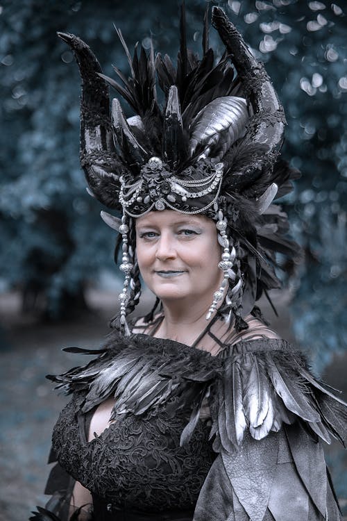 Woman Wearing a Headdress with Horns and Feathers