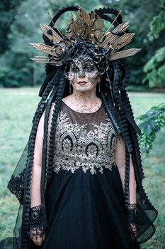 Woman in elaborate fantasy costume with headdress outdoors in Leipzig park.