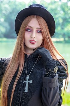 Close-up of a stylish woman in gothic attire posing outdoors in Leipzig.