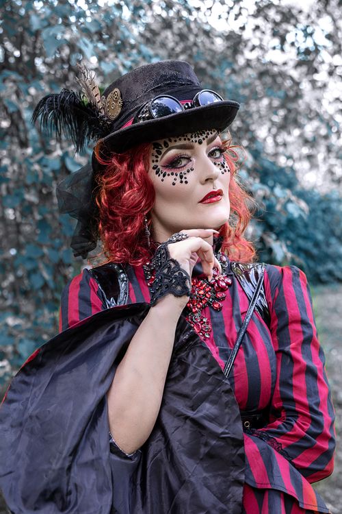Free Elegant woman in steampunk attire poses in Leipzig park, showcasing elaborate makeup and costume. Stock Photo