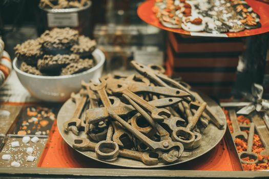 Creative display of chocolate shaped like tools in a Belgian shop.