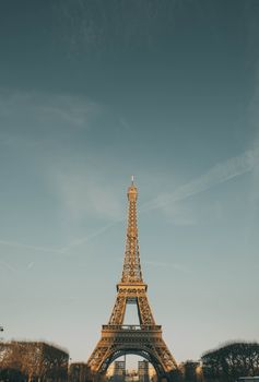 Scenic view of the iconic Eiffel Tower against a clear sky, highlighting its architectural beauty.