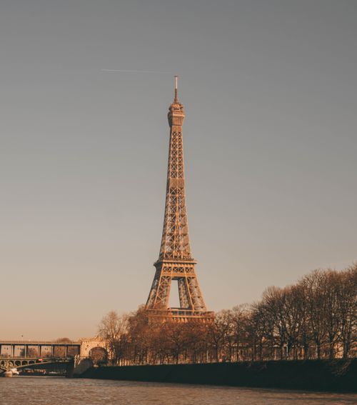 Free Captivating view of the Eiffel Tower during sunset in Paris, highlighting its iconic architecture. Stock Photo
