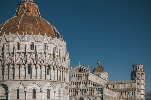 Capture of Pisa's landmarks including the Leaning Tower under a clear blue sky.