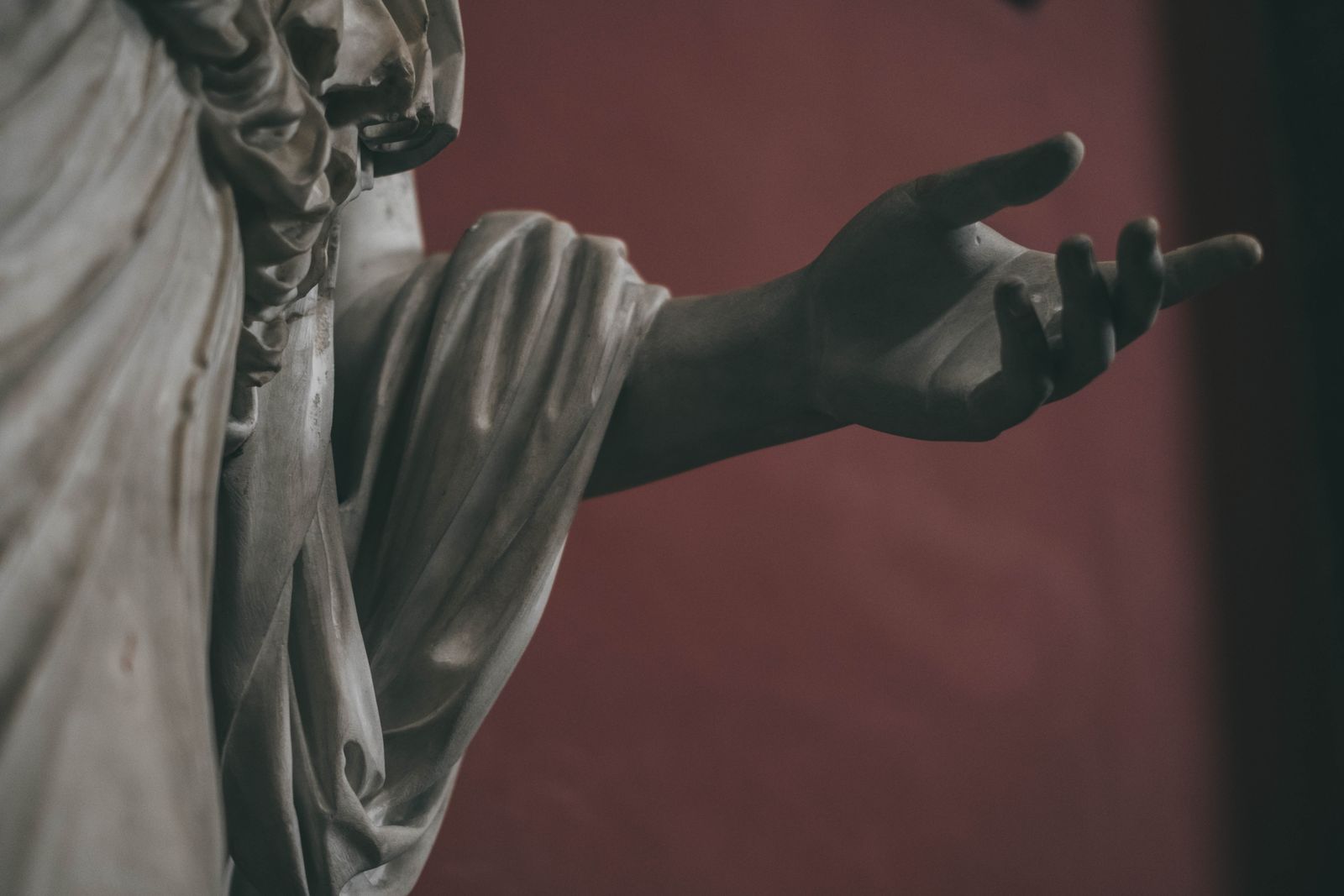 The carved hand of a marble figure, in monochrome — photo by Mark Amores on Pexels