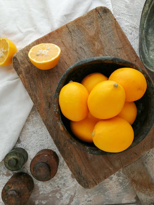 Orange Fruits in Brown Wooden Bucket