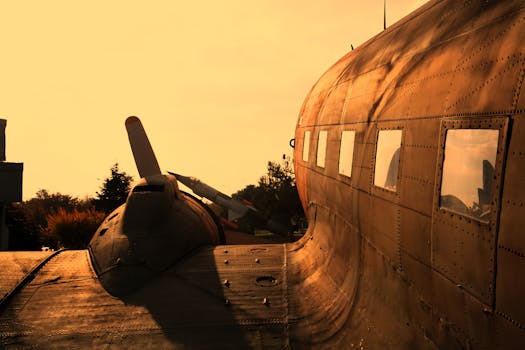 Close-up of a vintage airplane with an orange sky in Istanbul at sunset.