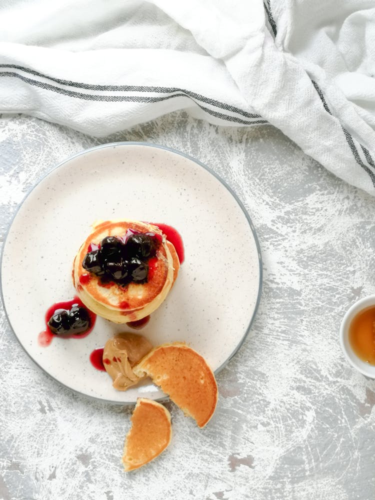 Pancake With Berry Toppings On A Ceramic Plate