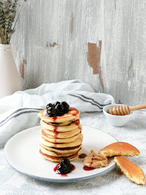 Free Pancakes With Black Berries on White Ceramic Plate Stock Photo