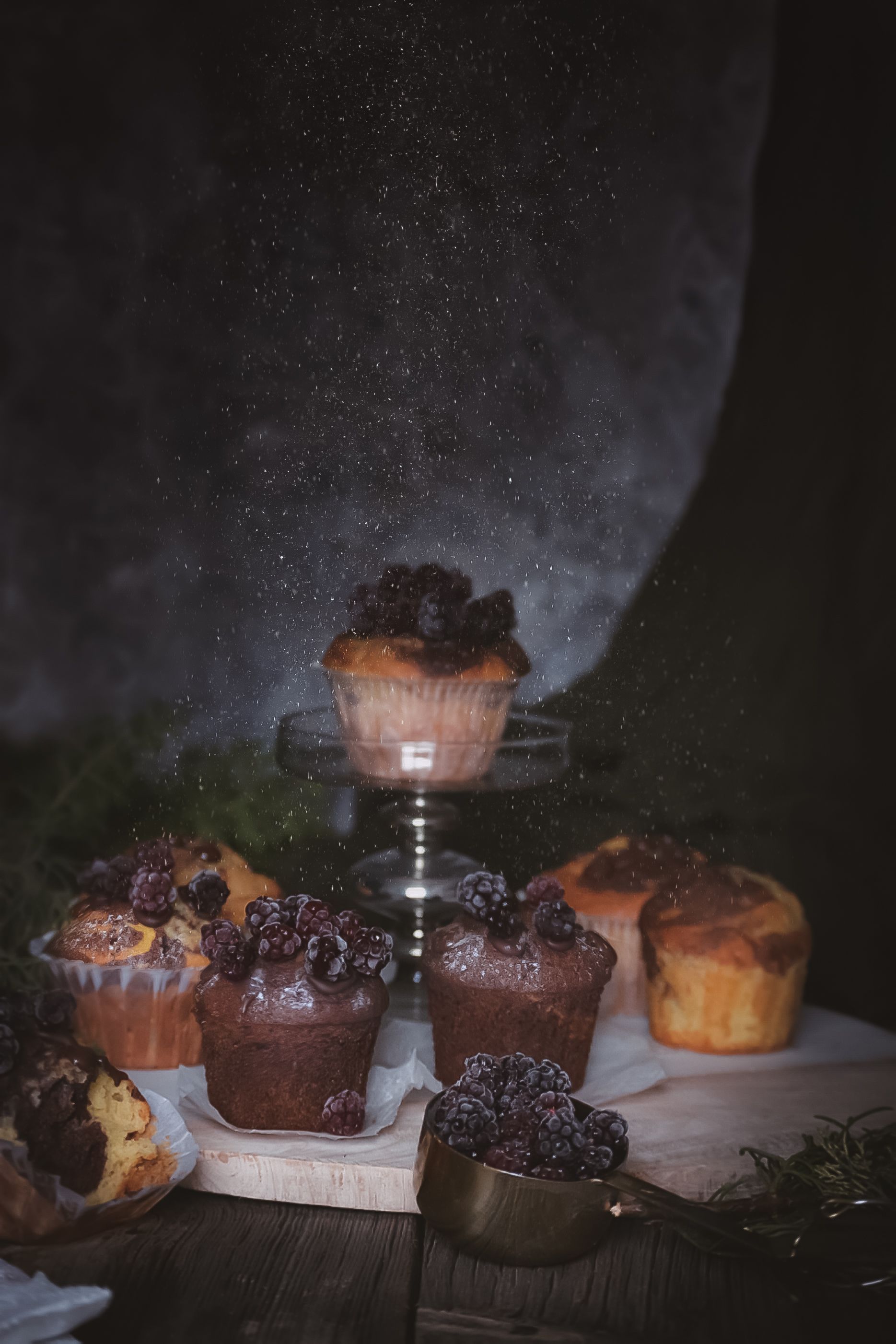 Captivating display of chocolate muffins dusted with sugar, perfect for dessert presentations.