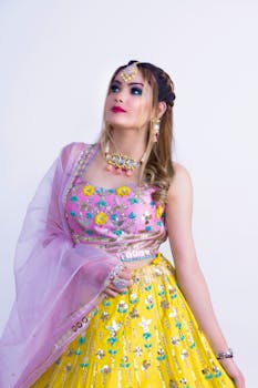 A woman in vibrant traditional wear gazes peacefully with a floral design outfit.