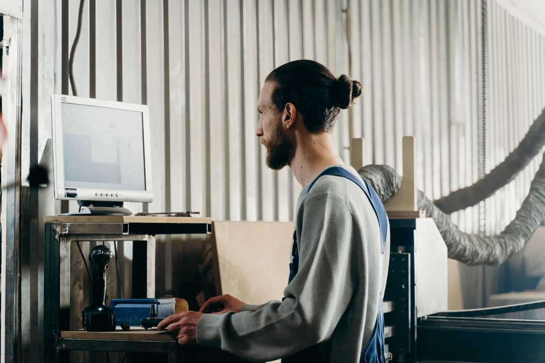 A Man in Gray Sweater Looking at the Screen of the Monitor · Free Stock ...