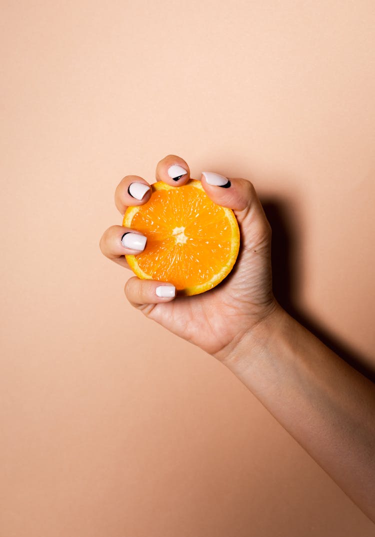 Person Squeezing A Juicy Orange 