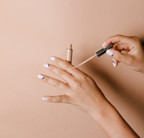 A Person Applying Concealer on Her Hand