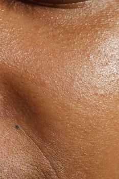 High-resolution close-up of human skin showing pores and texture for dermatology study.