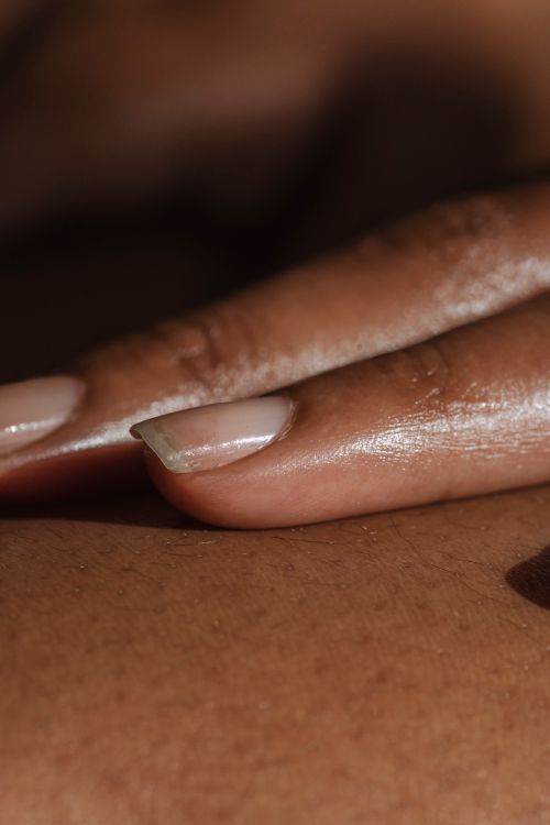 Free Detailed close-up of manicured nails gently touching skin, showing texture and care. Stock Photo