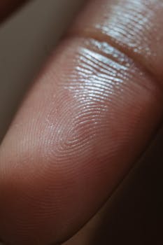 Macro view of a human fingerprint showcasing unique patterns on the skin.