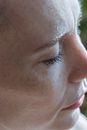 Persons Left Cheek With Black Hair