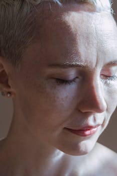 Close-up portrait of a woman with eyes closed, showcasing natural beauty and serene expression.