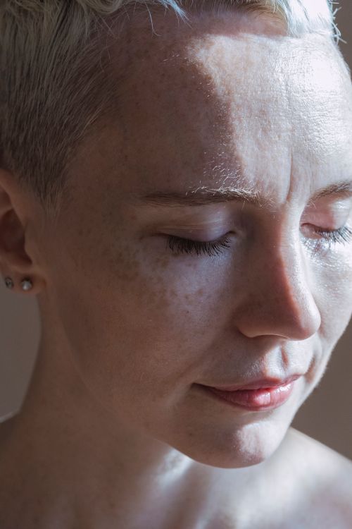 Free Close-up portrait of a woman with eyes closed, showcasing natural beauty and serene expression. Stock Photo