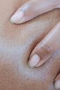 Persons Finger With White Nail Polish