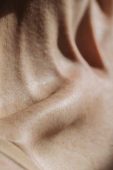 Intimate close-up shot highlighting the natural texture of human skin under soft lighting.