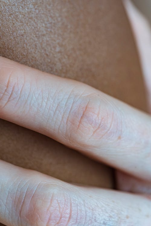 Closeup of crop anonymous person gently touching nude natural skin of African American partner